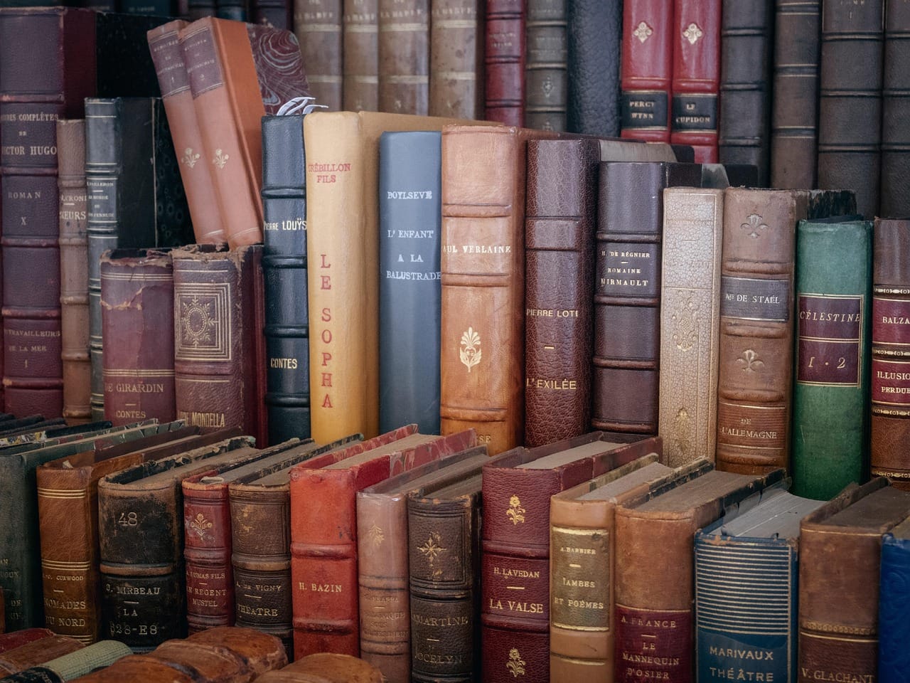 The shelf of books waiting for repair. It never gets shorter.